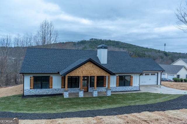 modern farmhouse with board and batten siding, driveway, a chimney, a garage, and a shingled roof