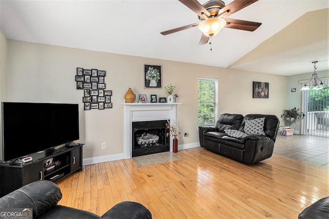 221 Hunters Xing SE, Calhoun, GA 30701 - living area featuring ceiling fan, a fireplace with flush hearth, vaulted ceiling, hardwood / wood-style flooring, and baseboards