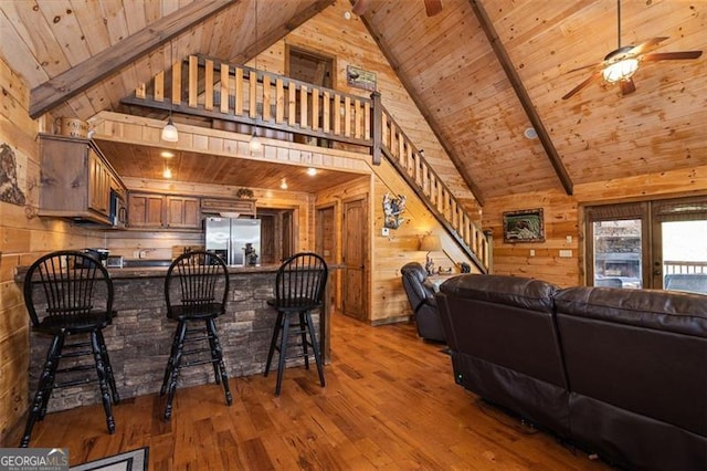 675 Green Ridge Rd, Blue Ridge, GA 30513 - living room featuring wood ceiling, a ceiling fan, hardwood / wood-style flooring, beam ceiling, and wooden walls