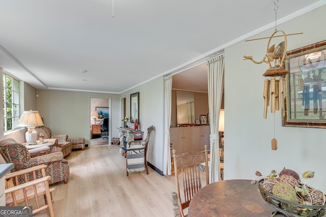 interior space with light wood-type flooring, ornamental molding, and baseboards