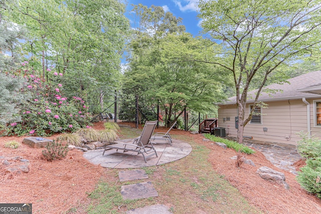view of yard featuring a patio and central AC
