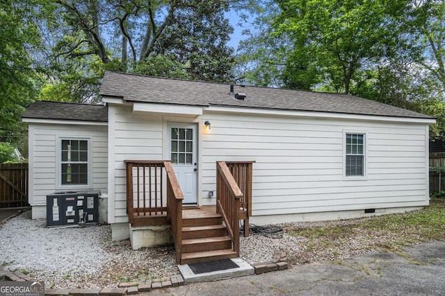 581 Taylor Dr SE, Smyrna, GA 30080 - back of house with central air condition unit, fence, a shingled roof, and crawl space