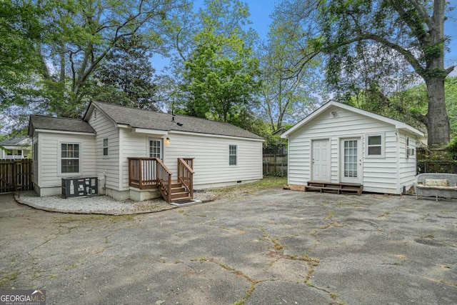 581 Taylor Dr SE, Smyrna, GA 30080 - rear view of property with an outdoor structure, roof with shingles, fence, and crawl space