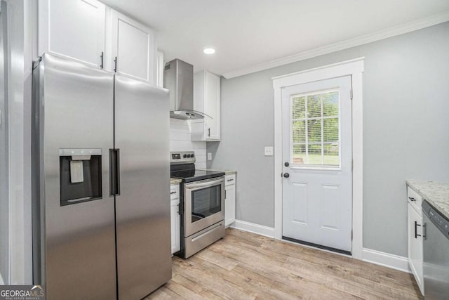 581 Taylor Dr SE, Smyrna, GA 30080 - kitchen featuring wall chimney range hood, crown molding, stainless steel appliances, white cabinetry, and light wood-type flooring