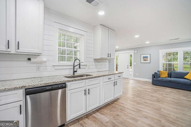 581 Taylor Dr SE, Smyrna, GA 30080 - kitchen featuring stainless steel dishwasher, visible vents, baseboards, a sink, and light wood finished floors