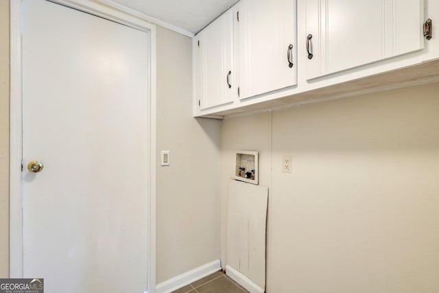 laundry room featuring baseboards, tile patterned flooring, cabinet space, and hookup for a washing machine