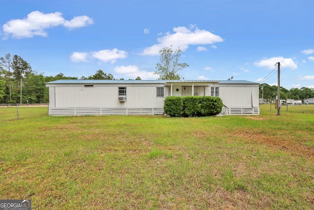 rear view of property featuring a yard