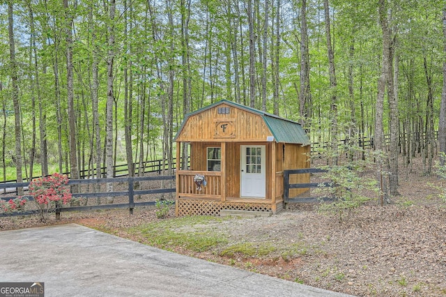 5419 Tyree Rd, Winston, GA 30187 - view of outdoor structure featuring fence, an outbuilding, and a forest view