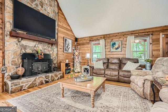 5419 Tyree Rd, Winston, GA 30187 - living area featuring wooden walls, high vaulted ceiling, a wood stove, and wood finished floors