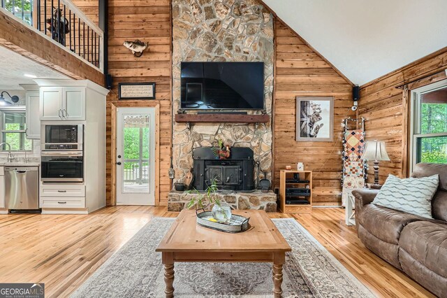 5419 Tyree Rd, Winston, GA 30187 - living area with light wood-type flooring, wood walls, and high vaulted ceiling