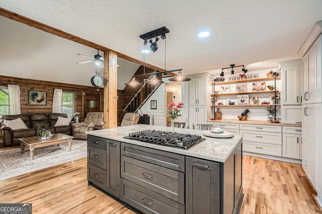 5419 Tyree Rd, Winston, GA 30187 - kitchen with a textured ceiling, open floor plan, black gas stovetop, and light wood-type flooring