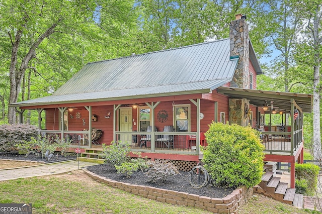 5419 Tyree Rd, Winston, GA 30187 - rustic home with a ceiling fan, covered porch, a chimney, and metal roof
