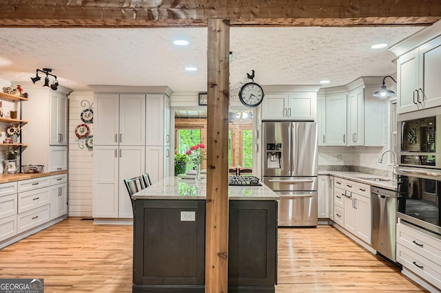 5419 Tyree Rd, Winston, GA 30187 - kitchen featuring a kitchen island, appliances with stainless steel finishes, a sink, and light wood finished floors