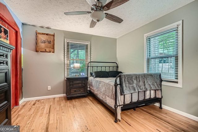 5419 Tyree Rd, Winston, GA 30187 - bedroom featuring baseboards, a ceiling fan, a textured ceiling, and light wood-style flooring