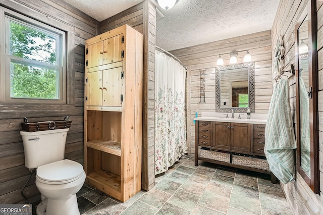 5419 Tyree Rd, Winston, GA 30187 - full bathroom with wooden walls, vanity, toilet, a shower with shower curtain, and stone tile floors