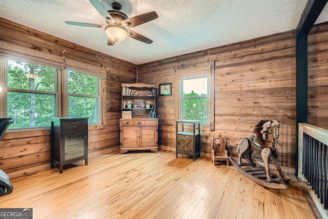5419 Tyree Rd, Winston, GA 30187 - interior space featuring wooden walls, ceiling fan, a wealth of natural light, and hardwood / wood-style flooring