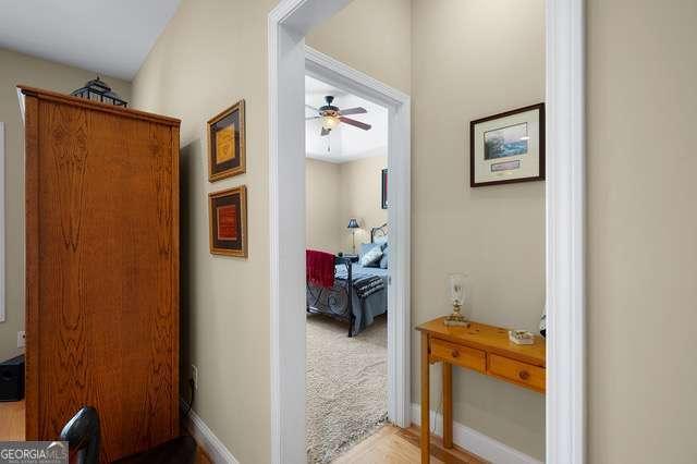 hallway featuring baseboards and wood finished floors