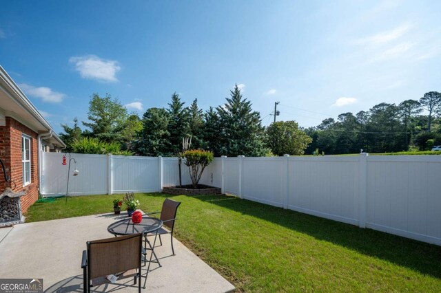 view of yard featuring a fenced backyard and a patio