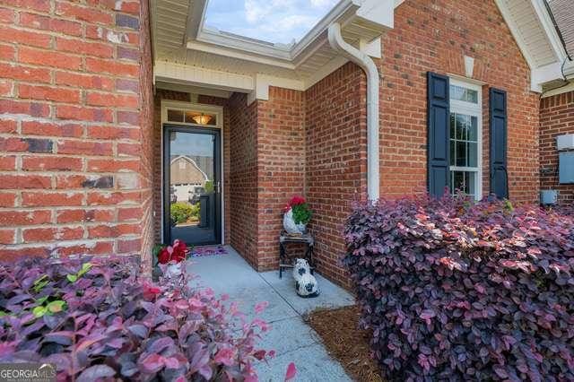 doorway to property featuring brick siding