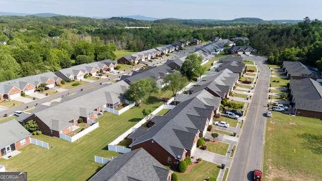 bird's eye view featuring a view of trees and a residential view