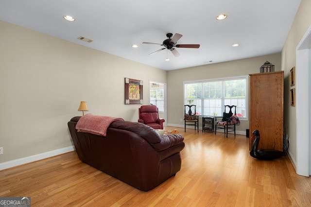 living area with visible vents, baseboards, recessed lighting, a ceiling fan, and light wood-style flooring