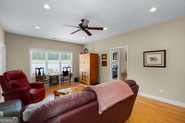 living room with recessed lighting, ceiling fan, baseboards, and light wood-style floors