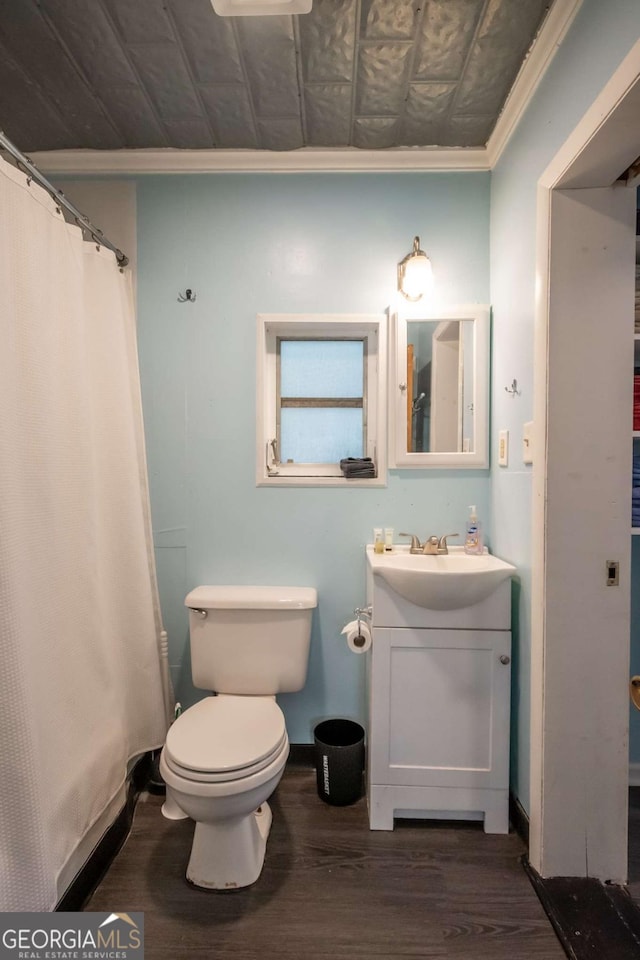 full bathroom featuring crown molding, vanity, toilet, baseboards, and wood finished floors
