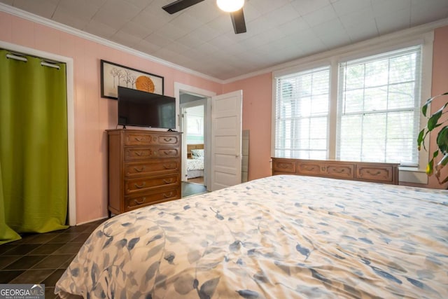 bedroom featuring ornamental molding, ceiling fan, and multiple windows
