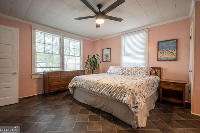 bedroom featuring crown molding, dark tile patterned flooring, and ceiling fan