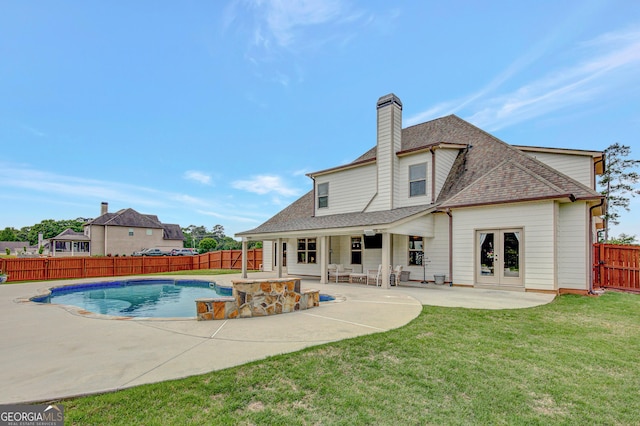 view of pool with a fenced backyard, french doors, a fenced in pool, a patio area, and a yard