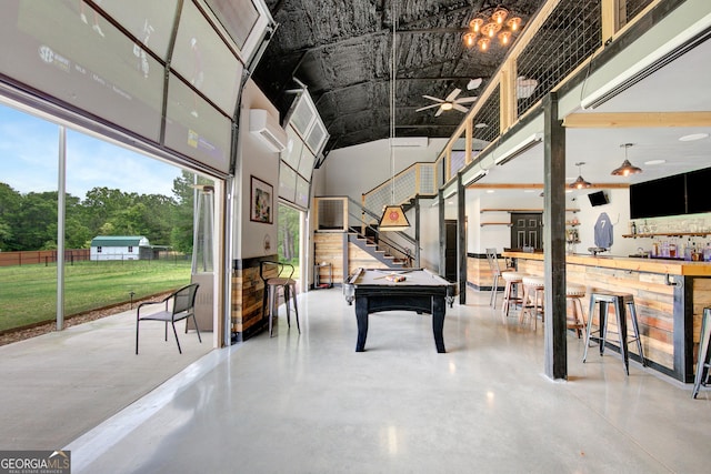 game room featuring concrete flooring, a wall mounted air conditioner, and a towering ceiling