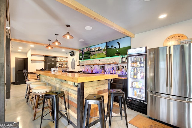 bar featuring freestanding refrigerator, concrete flooring, beamed ceiling, recessed lighting, and a community bar