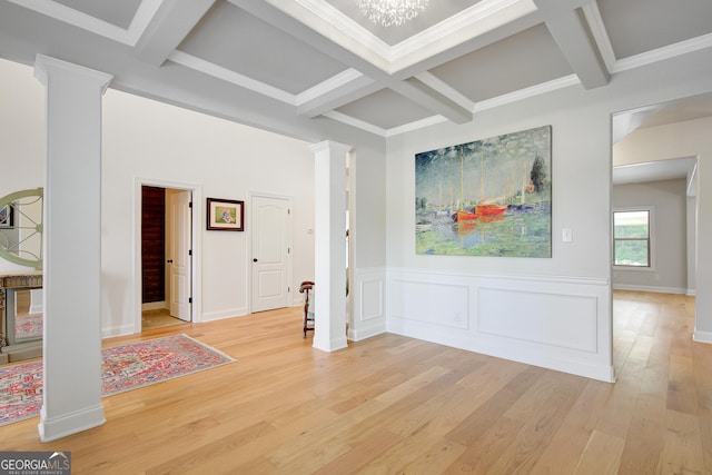 interior space featuring decorative columns, beam ceiling, light wood finished floors, and coffered ceiling