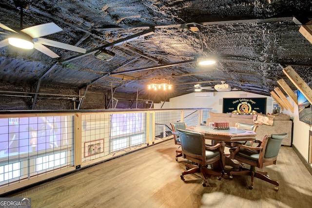 interior space featuring ceiling fan, wood finished floors, and lofted ceiling