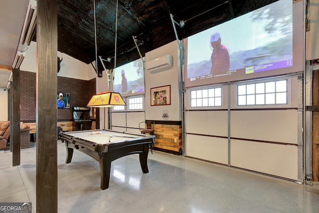 rec room with finished concrete floors, pool table, an AC wall unit, and high vaulted ceiling