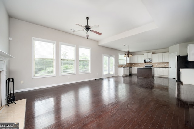 108 Franklin St, Braselton, GA 30517 - unfurnished living room featuring baseboards, dark wood-style flooring, and ceiling fan