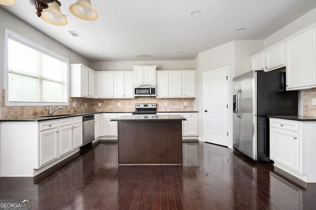 108 Franklin St, Braselton, GA 30517 - kitchen featuring decorative backsplash, a kitchen island, dark countertops, a sink, and stainless steel appliances