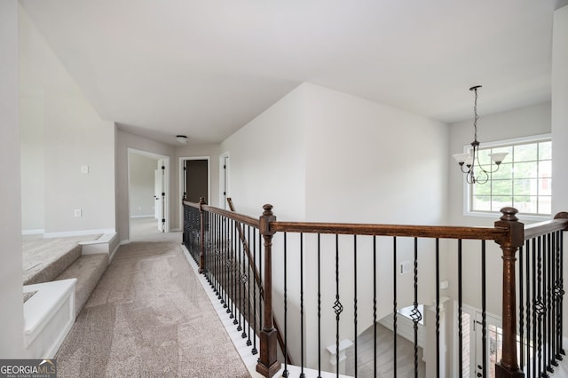 108 Franklin St, Braselton, GA 30517 - corridor with an inviting chandelier, carpet, baseboards, and an upstairs landing