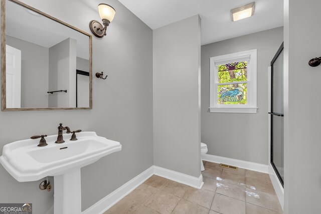bathroom with visible vents, a shower stall, baseboards, tile patterned floors, and toilet