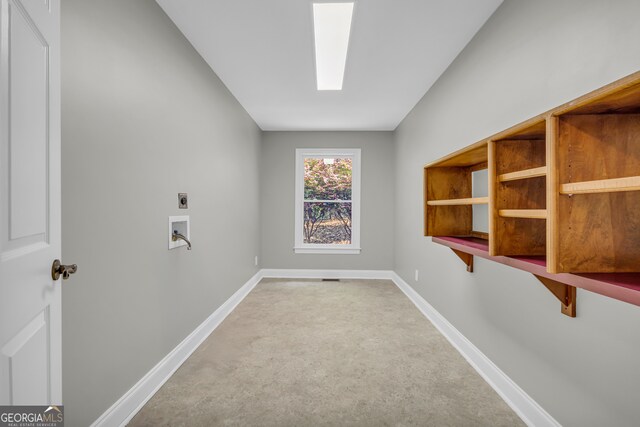washroom with hookup for an electric dryer, laundry area, a skylight, baseboards, and carpet flooring