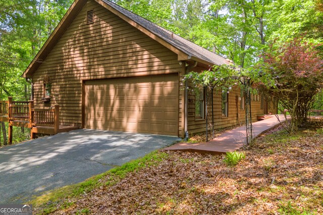 view of side of property with aphalt driveway