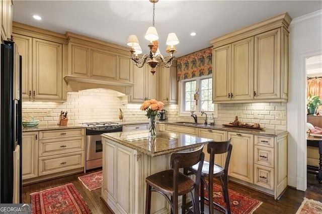 45 Paces W Dr NW, Atlanta, GA 30327 - kitchen featuring a sink, light stone counters, stainless steel gas range, freestanding refrigerator, and an inviting chandelier