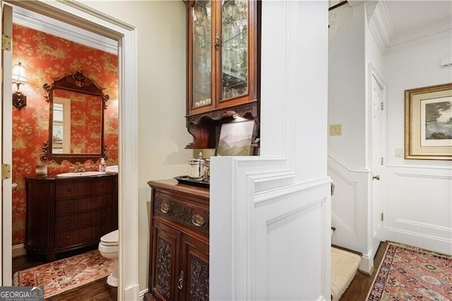 45 Paces W Dr NW, Atlanta, GA 30327 - interior space featuring crown molding, dark wood finished floors, a sink, a wainscoted wall, and a decorative wall