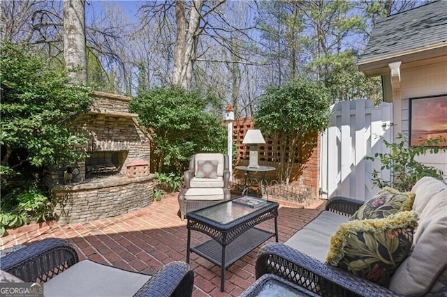 45 Paces W Dr NW, Atlanta, GA 30327 - view of patio / terrace with fence and an outdoor living space with a fireplace