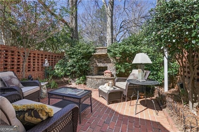 45 Paces W Dr NW, Atlanta, GA 30327 - view of patio / terrace featuring an outdoor living space with a fireplace