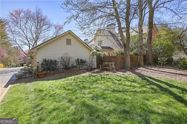 45 Paces W Dr NW, Atlanta, GA 30327 - view of side of home featuring a lawn and fence