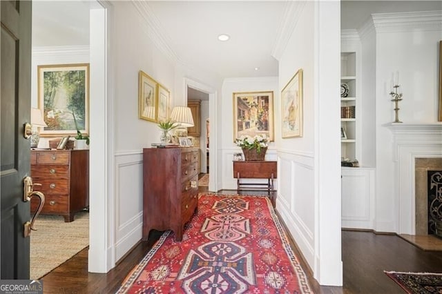 45 Paces W Dr NW, Atlanta, GA 30327 - hall featuring ornamental molding, wainscoting, a decorative wall, dark wood-style floors, and built in shelves