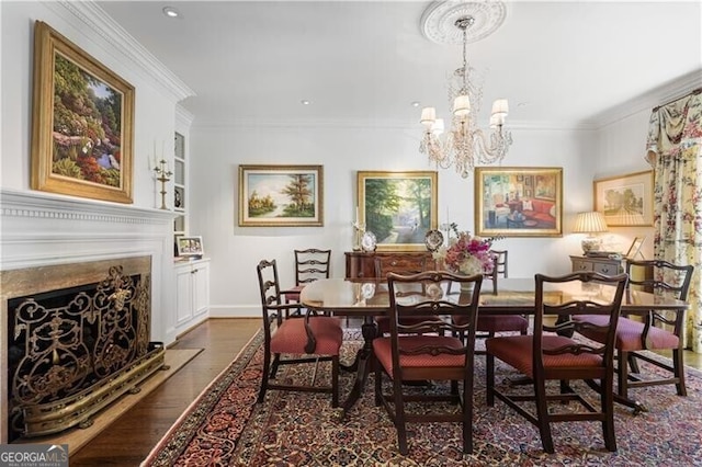 45 Paces W Dr NW, Atlanta, GA 30327 - dining space with dark wood-style flooring, a notable chandelier, a fireplace, built in features, and ornamental molding