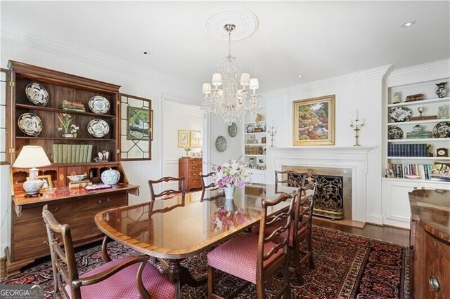45 Paces W Dr NW, Atlanta, GA 30327 - dining area with an inviting chandelier, a fireplace with flush hearth, crown molding, and wood finished floors