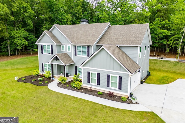 445 Boulder Crest Trl, Villa Rica, GA 30180 - craftsman-style house with board and batten siding, a shingled roof, and a front yard
